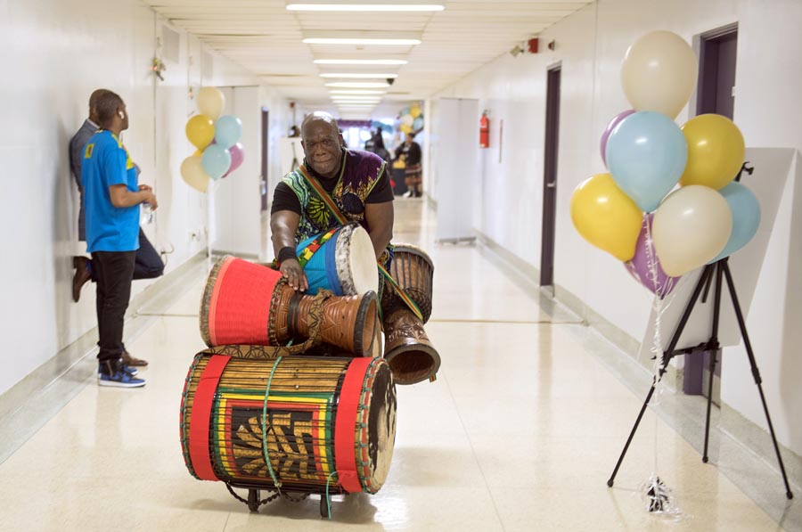 Drummer transporting the drums. Open Gallery